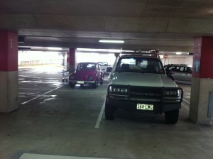 Landcruiser being stalked by cute purple Volkswagen at Carindale Shopping Centre